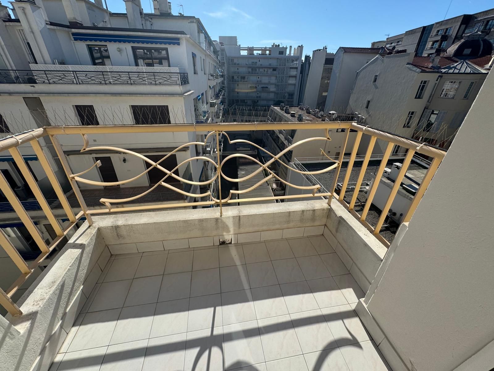 Terrasse carrelée plein sud avec garde-corps en fer forgé